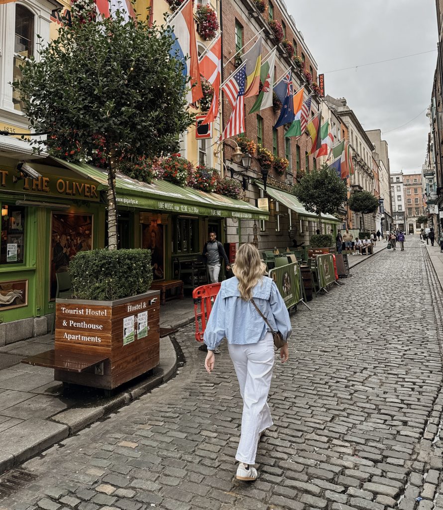 Woman walking through the colorful streets of Temple Bar in Dublin, Ireland