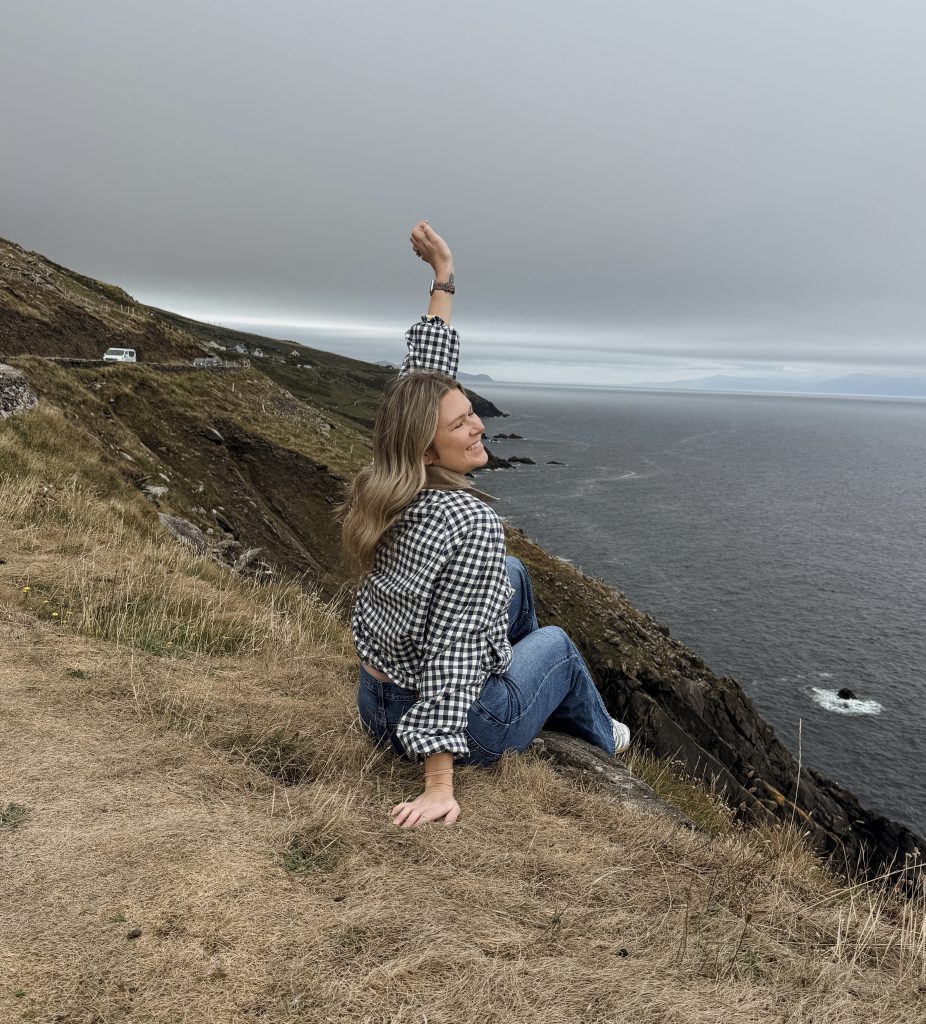 Women sitting at Slea Head Viewing point on Dingle Peninsula in Ireland