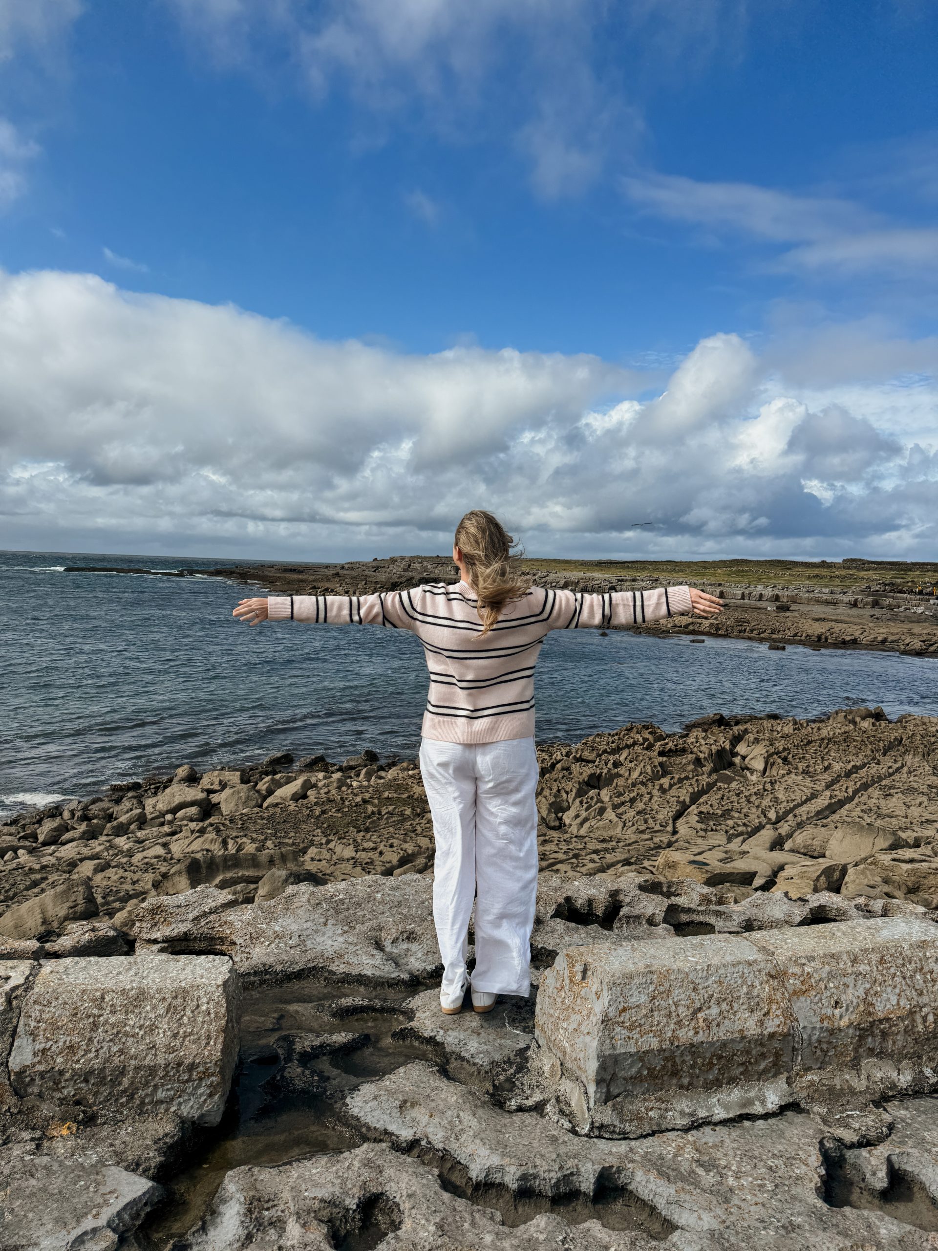 Women looking out at Tra Leathan at Doolin Pier in Doolin, Ireland