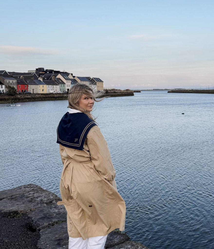 Woman posing in front of the Long Walk in Galway, Ireland