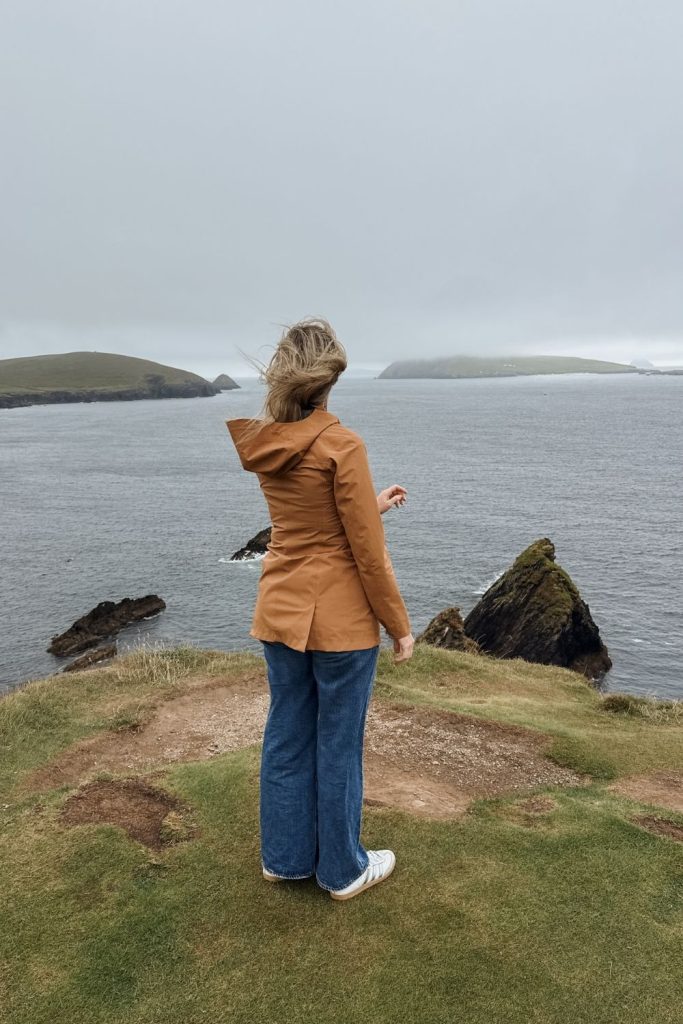 Woman standing at Dunquin Pier on the Dingle Peninsula in Ireland