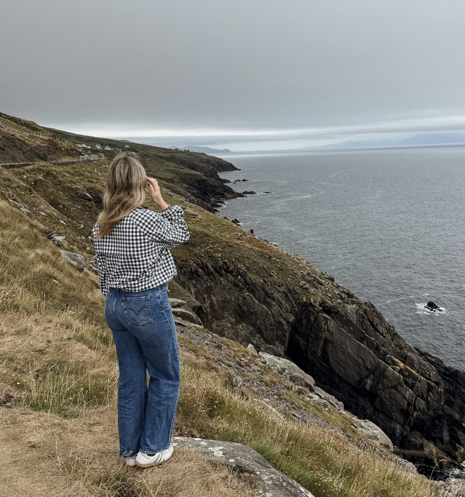 Woman standing at Slea Head Viewing Point on the Dingle Peninsula in Ireland