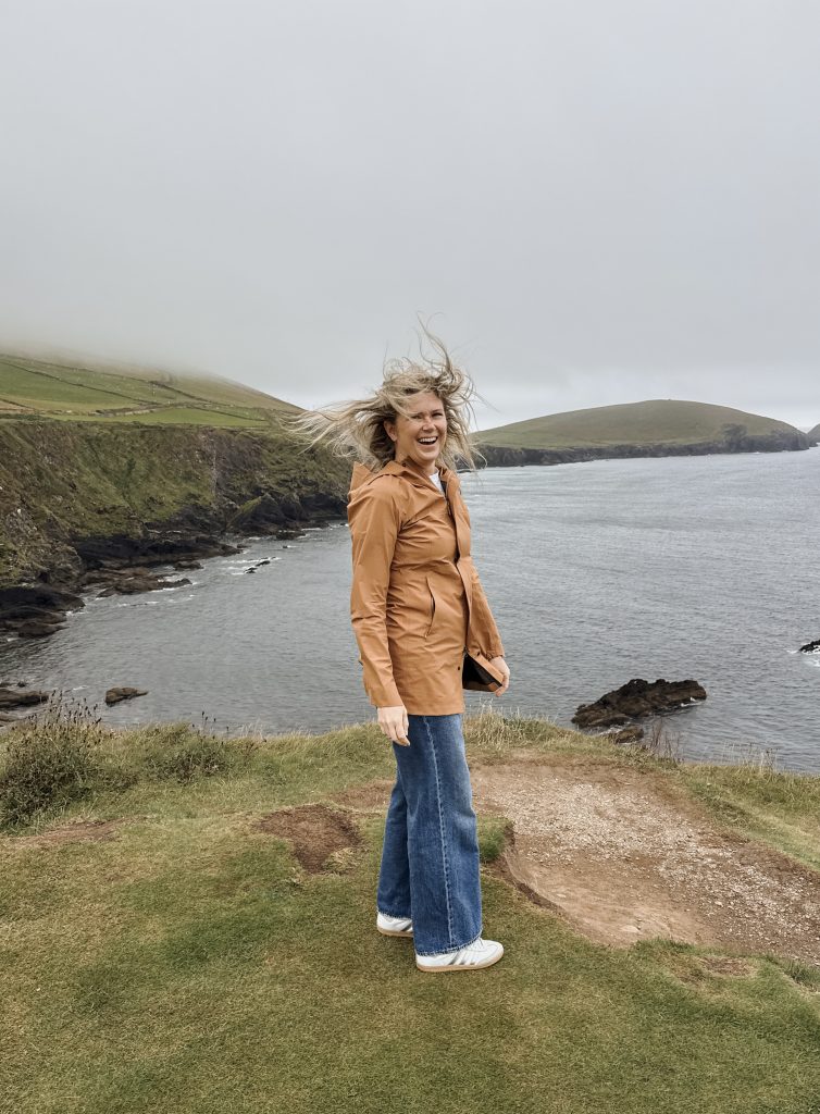 Woman with hair blowing at Dunquin Pier in Ireland