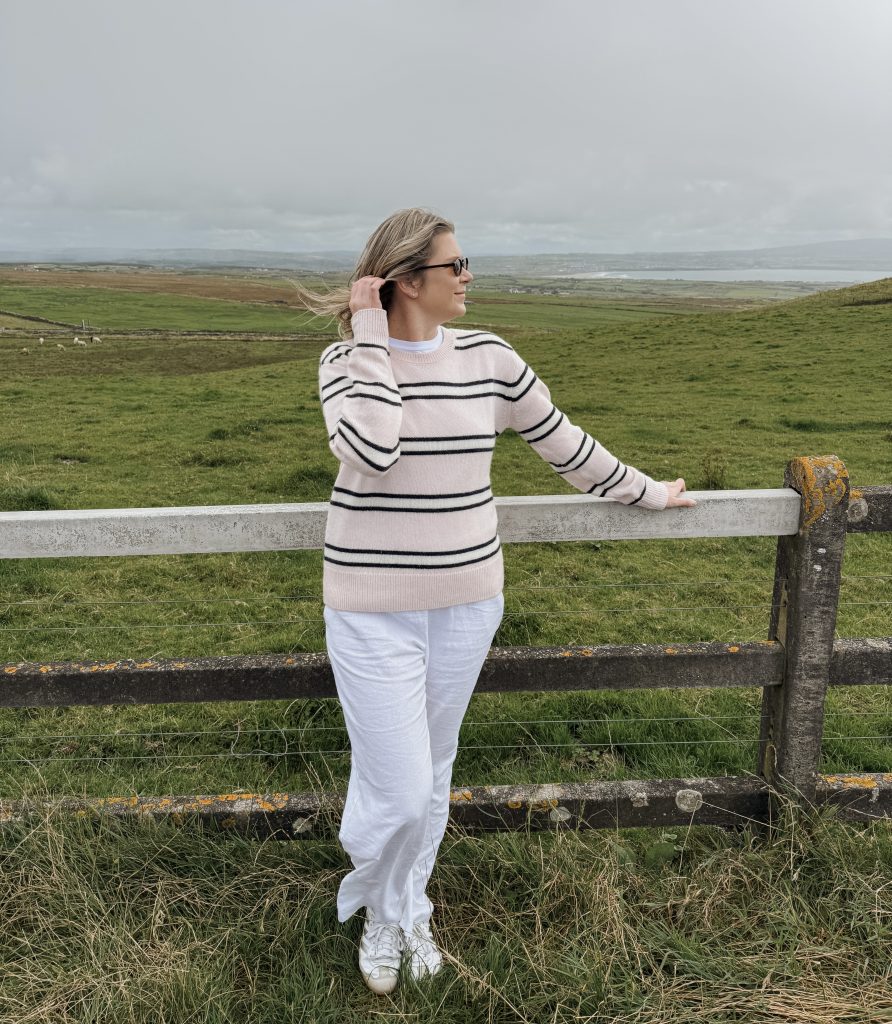 Woman in surrounding area of the Cliffs of Moher in Ireland