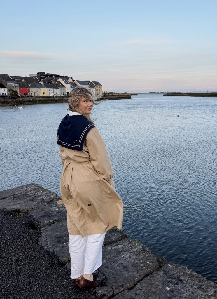 Woman standing at The Long Walk colorful houses in Galway, Ireland